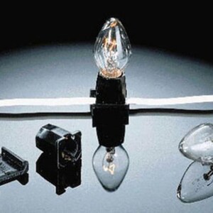 May include: A string of clear incandescent light bulbs with black plastic sockets attached to a white wire. The set includes individual clear glass bulbs with metal screw bases and separate black plastic socket components for assembly and repair.