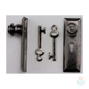 May include: A set of miniature dark metal hardware including a door handle on a rectangular plate, two small keys, and a rectangular door plate with a round knob and a keyhole. The text AAM All About Miniatures is in the corner.