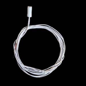 May include: A white electrical wire coiled into a circular shape, featuring a small, cylindrical white connector at one end. The wire is thin and flexible, with a smooth white insulation coating that extends from the connector throughout the length.
