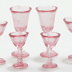 May include: Set of six pink glass stemmed goblets, including a coupe, a martini glass, and four wine glasses.