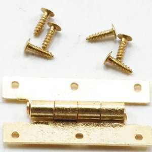May include: Gold-toned metal hinge with four brass screws. The hinge is made of two plates connected by a barrel-shaped joint.