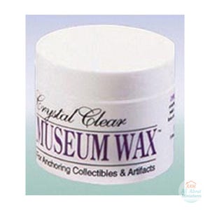 May include: A white cylindrical container of Crystal Clear Museum Wax for anchoring collectibles and artifacts. The label features black text with the product name prominently displayed in a bold, serif font on the front side.