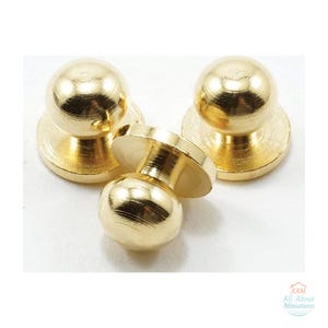 May include: Three small, round, gold-colored metal buttons with a smooth, reflective finish. Each button features a spherical top attached to a flat, circular base. The text AAM All About Miniatures is visible in the bottom right corner.
