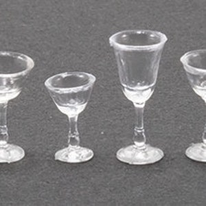 May include: Six clear miniature wine glasses with varying bowl shapes and stem designs. The glasses are arranged in a row, showcasing their delicate construction and transparent appearance. Perfect for dollhouses or miniature displays.