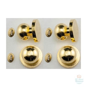 May include: Two sets of gold-colored metal door knobs, each featuring a spherical handle and a flat circular base. Beside each knob is a small, oval-shaped metal keyhole plate. The text AAM All About Miniatures is visible in the corner.