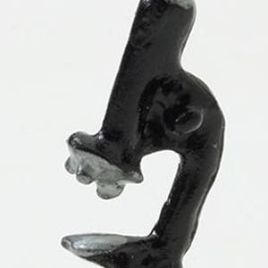 May include: A small, hand-painted figurine of a microscope featuring a glossy black body with silver accents on the eyepiece, objective lenses, and stage. The object has a curved stand and a flat base, rendered in a solid, molded material.