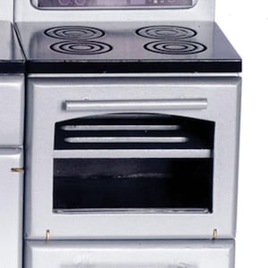May include: A miniature silver-colored stove with a black stovetop featuring four circular burners. The control panel displays the time 12:00 in green digital text. The unit includes an oven door with a horizontal handle and a bottom storage drawer.