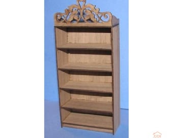 May include: A miniature wooden bookshelf featuring five open shelves and a decorative, laser-cut scrollwork pediment at the top. The unit is constructed from light-colored wood with visible grain and dark edges. The text AAM All About Miniatures is visible.