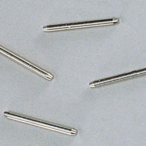 May include: Four silver-toned metal spring bars, each featuring a thin cylindrical body with small, retractable pins at both ends. These components are designed for watch strap attachment and are arranged in a scattered pattern on a neutral surface.