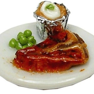 May include: A white plate with a grilled steak, peas, and a baked potato in foil. The steak is glazed with a brown sauce.