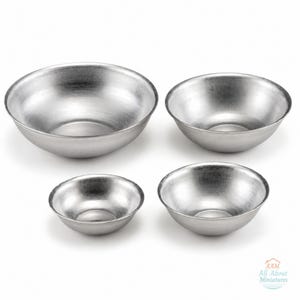 May include: A set of four silver-toned metal bowls in varying sizes, featuring a smooth, brushed finish and rounded edges. The bowls are arranged in a group, with the text AAM All About Miniatures visible in the bottom right corner.