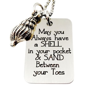 May include: Silver necklace with a seashell charm and a tag that reads "May you Always have a SHELL in your pocket & SAND Between your Toes".
