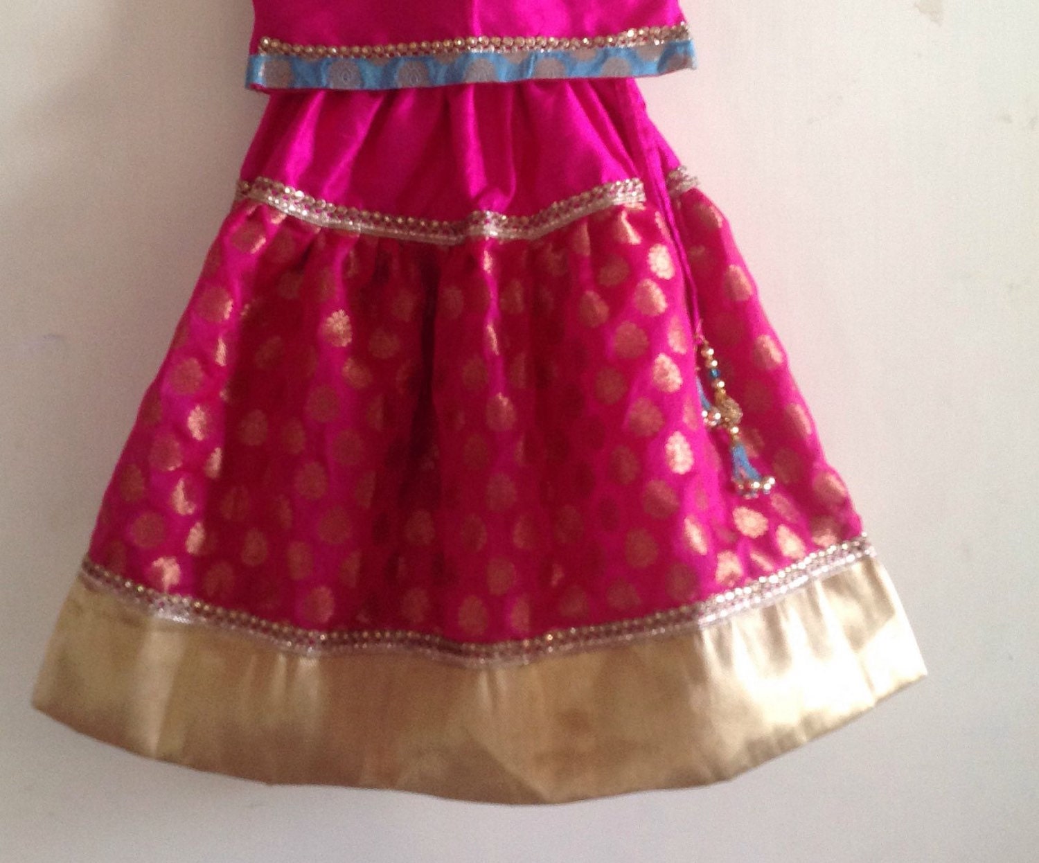Rich Brocade Gold And Pink Netted Unique Lehenga Set
