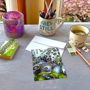 May include: A set of three ceramic mugs with a speckled, matte finish. The mugs are in shades of cream, light gray, and dark gray. Each mug has a simple, minimalist design, perfect for coffee or tea.