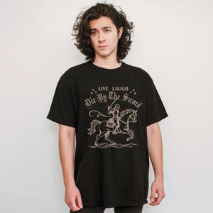 live laugh die by the sword. funny medieval meme graphic tee for the ren faire. trendy for men and women. oversize fit. comfort color t-shirt available in plus sizes.