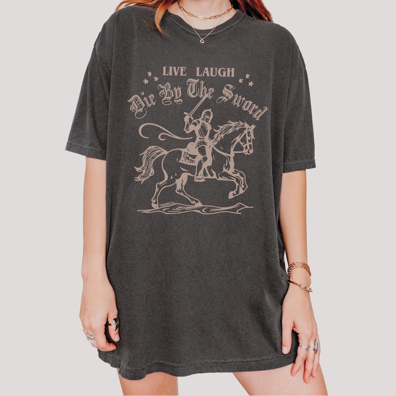 live laugh die by the sword. funny medieval meme graphic tee for the ren faire. trendy for men and women. oversize fit. comfort color t-shirt available in plus sizes.