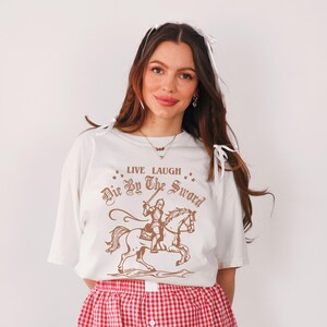 live laugh die by the sword. funny medieval meme graphic tee for the ren faire. trendy for men and women. oversize fit. comfort color t-shirt available in plus sizes.
