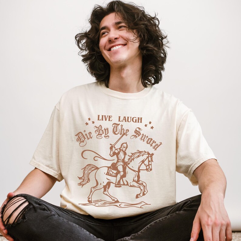 live laugh die by the sword. funny medieval meme graphic tee for the ren faire. trendy for men and women. oversize fit. comfort color t-shirt available in plus sizes.