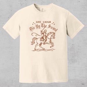 live laugh die by the sword. funny medieval meme graphic tee for the ren faire. trendy for men and women. oversize fit. comfort color t-shirt available in plus sizes.