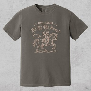 live laugh die by the sword. funny medieval meme graphic tee for the ren faire. trendy for men and women. oversize fit. comfort color t-shirt available in plus sizes.