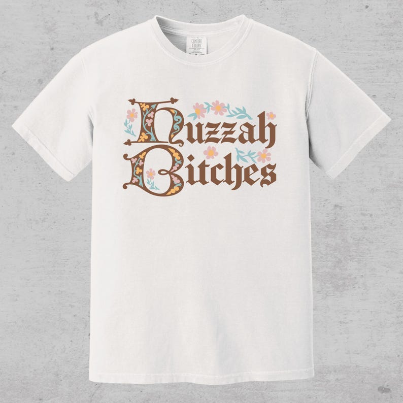 huzzah bitches funny medieval meme graphic tee on a comfort color t-shirt available in plus sizes and gender neutral