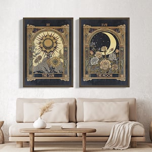 May include: Two framed prints with a dark blue background and gold accents. The left print features a sun with the text "XIX THE SUN" and the right print features a crescent moon with the text "XVIII THE MOON".