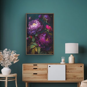 May include: A framed floral print featuring a bouquet of purple and pink peonies on a dark green background. The print is displayed on a wall above a wooden dresser.