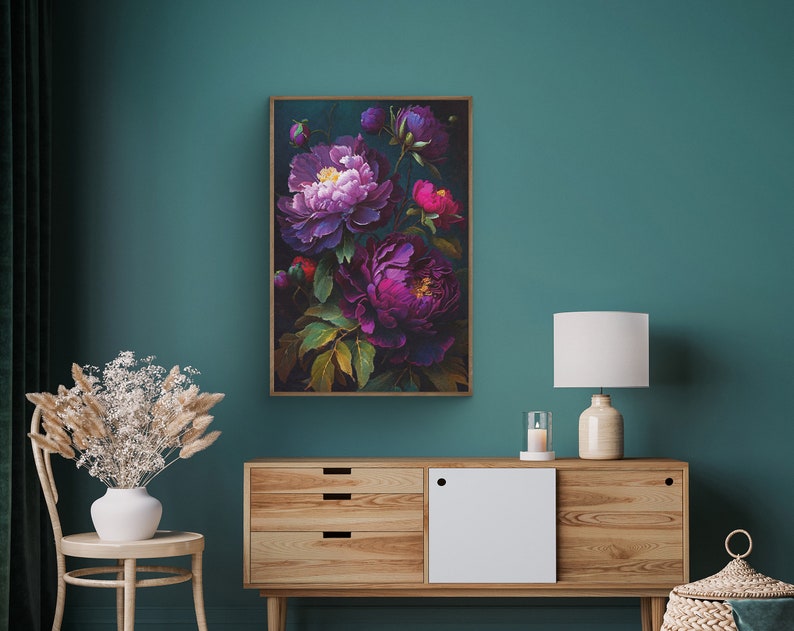 May include: A framed floral print featuring a bouquet of purple and pink peonies on a dark green background. The print is displayed on a wall above a wooden dresser.