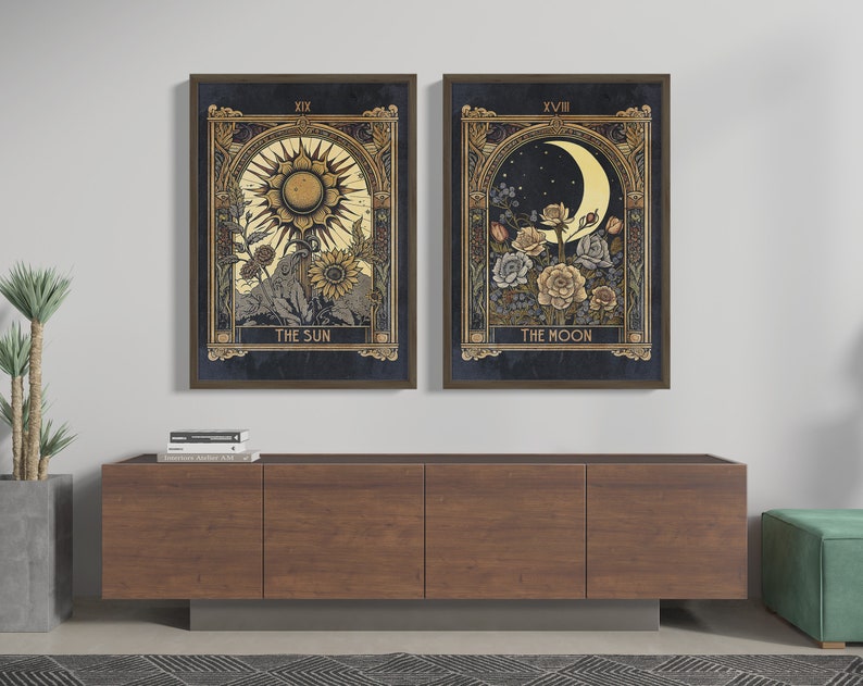 May include: Two framed prints of tarot cards, The Sun and The Moon. The Sun card features a sun with a face and rays, surrounded by flowers. The Moon card features a crescent moon with a face, surrounded by flowers.