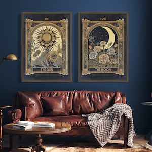 May include: Two framed prints with gold accents, depicting tarot cards. The left print shows the Sun card with a sun and flowers. The right print shows the Moon card with a crescent moon and flowers.