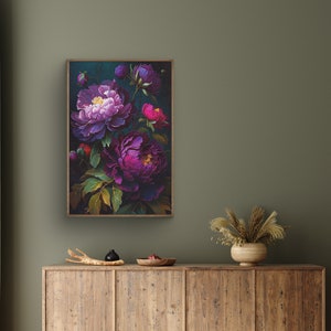 May include: A framed print of a dark floral still life featuring purple and pink peonies on a dark background.