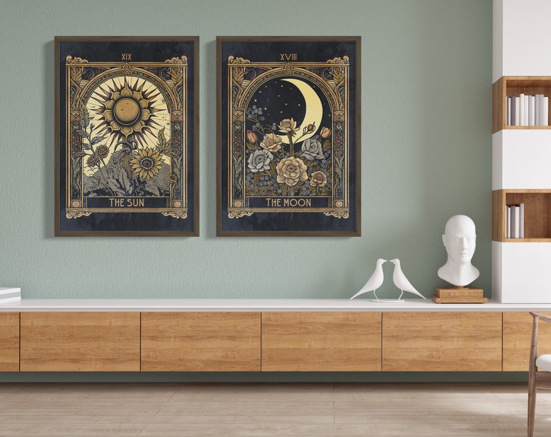 May include: Two framed prints of tarot cards, The Sun and The Moon, with gold accents and floral designs. The Sun card features a yellow sun with rays and the Moon card features a crescent moon with stars.