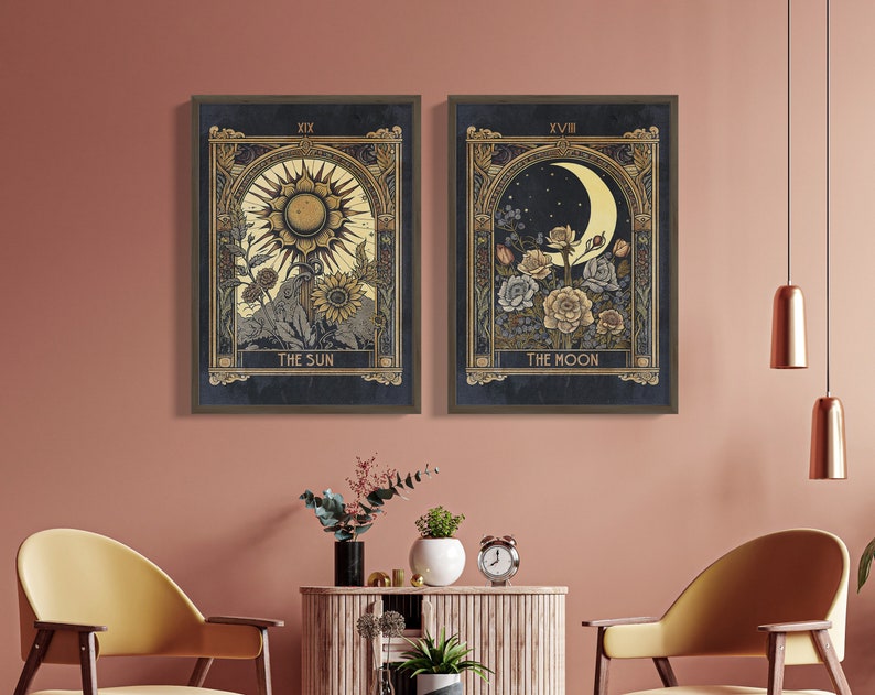 May include: Two framed tarot card prints, one depicting The Sun with a golden sun and sunflowers, and the other depicting The Moon with a crescent moon and flowers. Both prints have a dark blue background and gold accents.