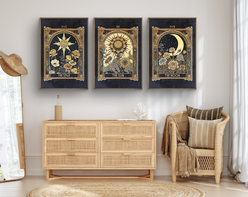 May include: Three framed prints with gold accents and a dark blue background. Each print features a celestial symbol, including a star, sun, and moon, with floral accents. The text below each image reads "The Star", "The Sun", and "The Moon".