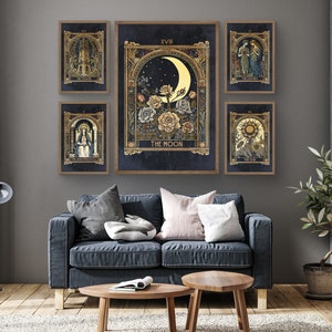 May include: A set of 7 tarot cards featuring illustrations of the Tower, The Lovers, The Moon, The High Priestess, The Sun, and The World. The cards are framed in gold and have a dark blue background.