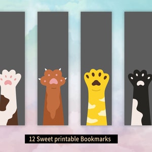 May include: Four printable bookmarks featuring different colored cat paws with pink paw pads. The bookmarks are on a gray background with a light blue and pink watercolor background.