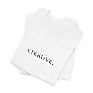 Kreativ - One Word Minimalist Unisex Jersey Kurzarm-T-Shirt
