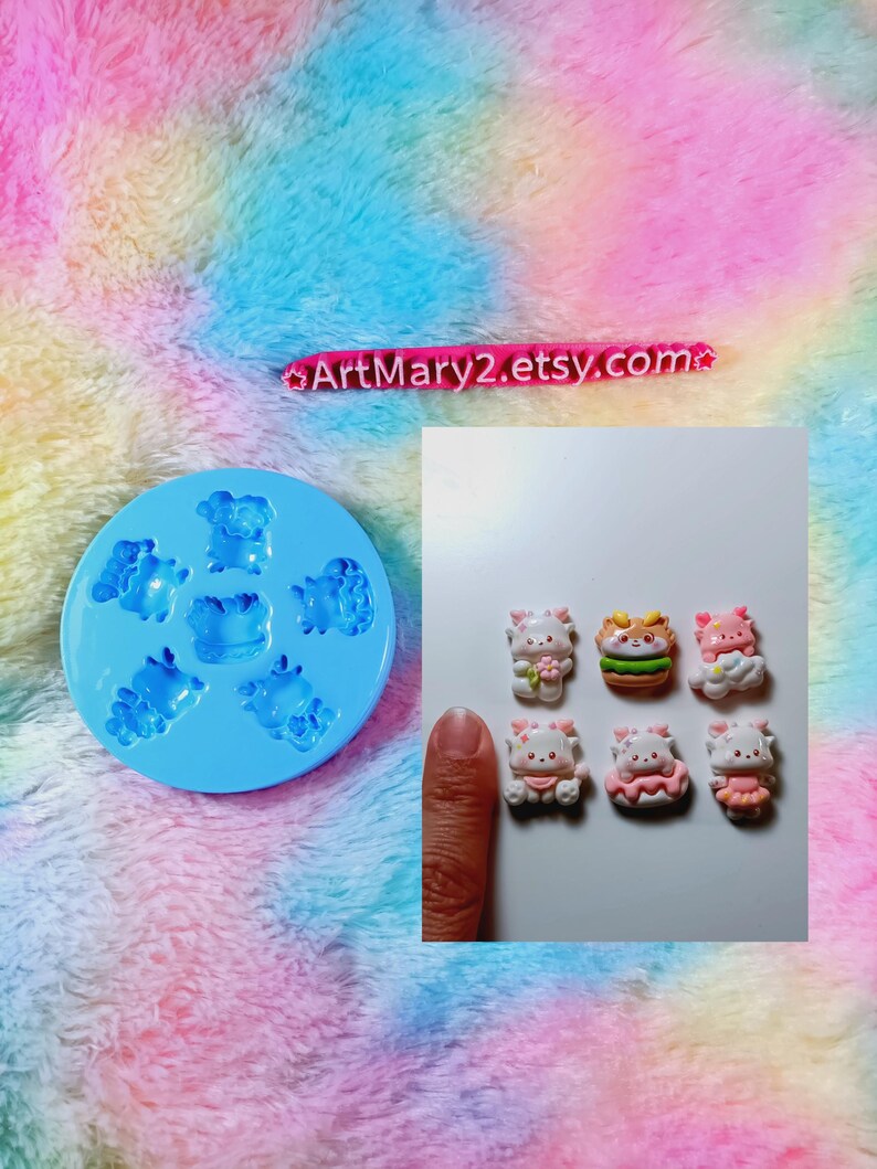 May include: A blue silicone mold with six cavities shaped like cute cartoon animals. The mold is next to six finished resin pieces, each with a different design. The resin pieces are about 1 inch in size.