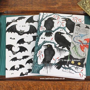 Gothic Crows Notebook featuring my original pen and ink illustrations, alongside my Gothic Bats Notebook, with vintage Victorian writing desk accessories. Made in the UK. Design and illustration © Nicola L Robinson | Teeth and Claws