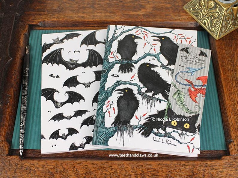 Gothic Crows Notebook featuring my original pen and ink illustrations, alongside my Gothic Bats Notebook, with vintage Victorian writing desk accessories. Made in the UK. Design and illustration © Nicola L Robinson | Teeth and Claws