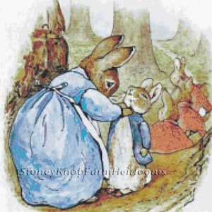 May include: A cross stitch pattern featuring a blue-clad rabbit mother with a brown rabbit child. The mother rabbit is holding the child's hand. The pattern is titled "Stoney Knob Family Heirlooms".