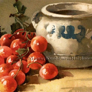 May include: A white ceramic pitcher with blue painted designs sits on a table next to a cluster of red cherries.