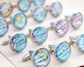 May include: A set of silver cufflinks with map designs. Each cufflink features a different city, including Sydney, Wollongong, Brisbane, Cape Town, and Miami.
