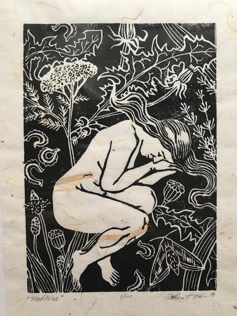 May include: Black and white woodcut print of a nude woman kneeling in a field of flowers. The print is titled "medicine" and numbered 2/100.