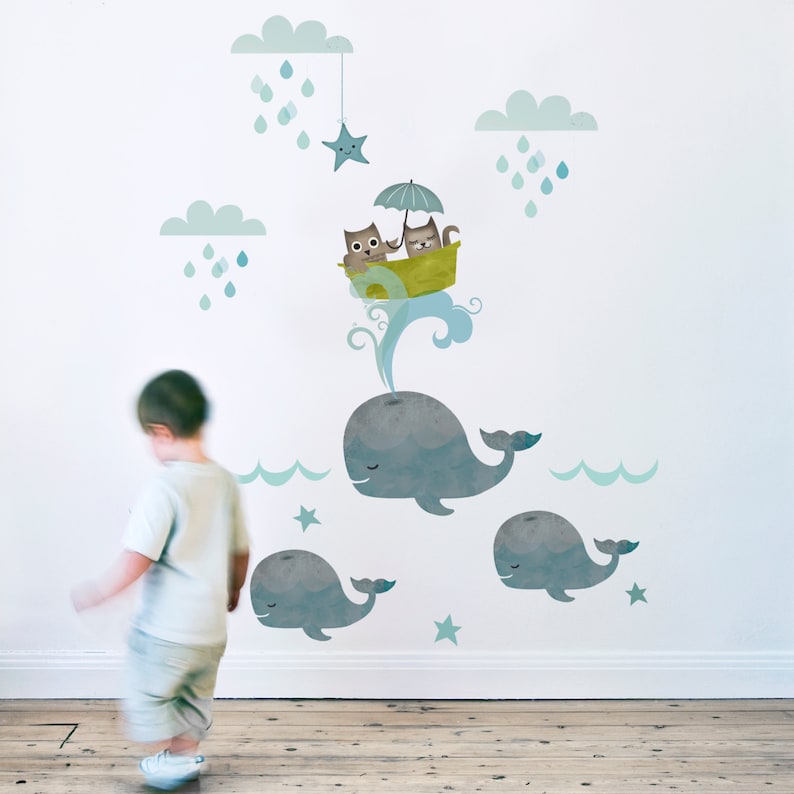 May include: A blue whale with a cat and owl in a boat with an umbrella on top of it. The whale is surrounded by clouds, stars, and raindrops.