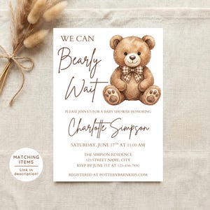 May include: A baby shower invitation featuring a watercolor illustration of a teddy bear with a plaid bow tie. The invitation reads "We Can Bearly Wait" and includes details for Charlotte Simpson's baby shower, including the date, time, and location.