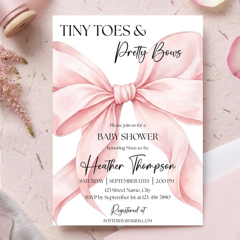 May include: A rectangular baby shower invitation card featuring a large, watercolor-style light pink ribbon bow centered on a white background. The text reads: TINY TOES & Pretty Bows, Please join us for a BABY SHOWER honoring Mom-to-be Heather Thompson, SATURDAY | SEPTEMBER 13TH | 2:00 PM, 123 Street Name, City, RSVP by September 1st at 123-456-7890, Registered at POTTERYBARNKIDS.COM.