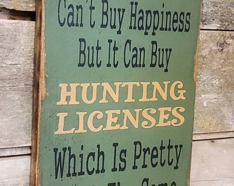 L&#39;argent ne fait pas le bonheur… mais il peut acheter des permis de chasse, ce qui est à peu près la même chose, patiné, panneau en bois