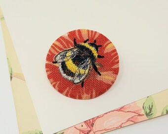 Embroidered bumble bee brooch.