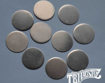 May include: Ten silver-colored metal discs, each with a smooth, round surface. The discs are arranged in a semi-circle pattern on a gray background.